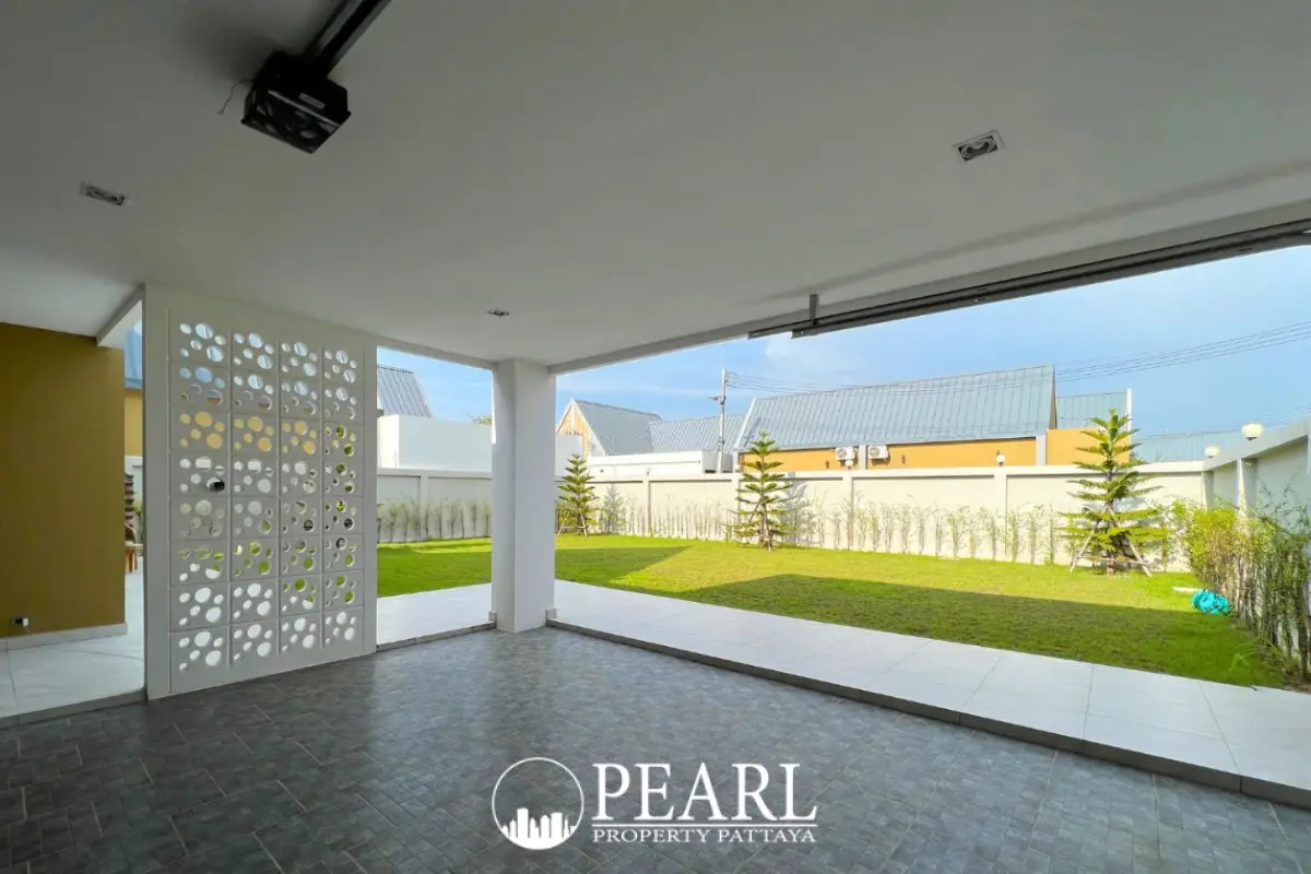 Baan Mae 2 Villa private courtyard with a rectangular swimming pool, outdoor seating, and glass sliding doors.