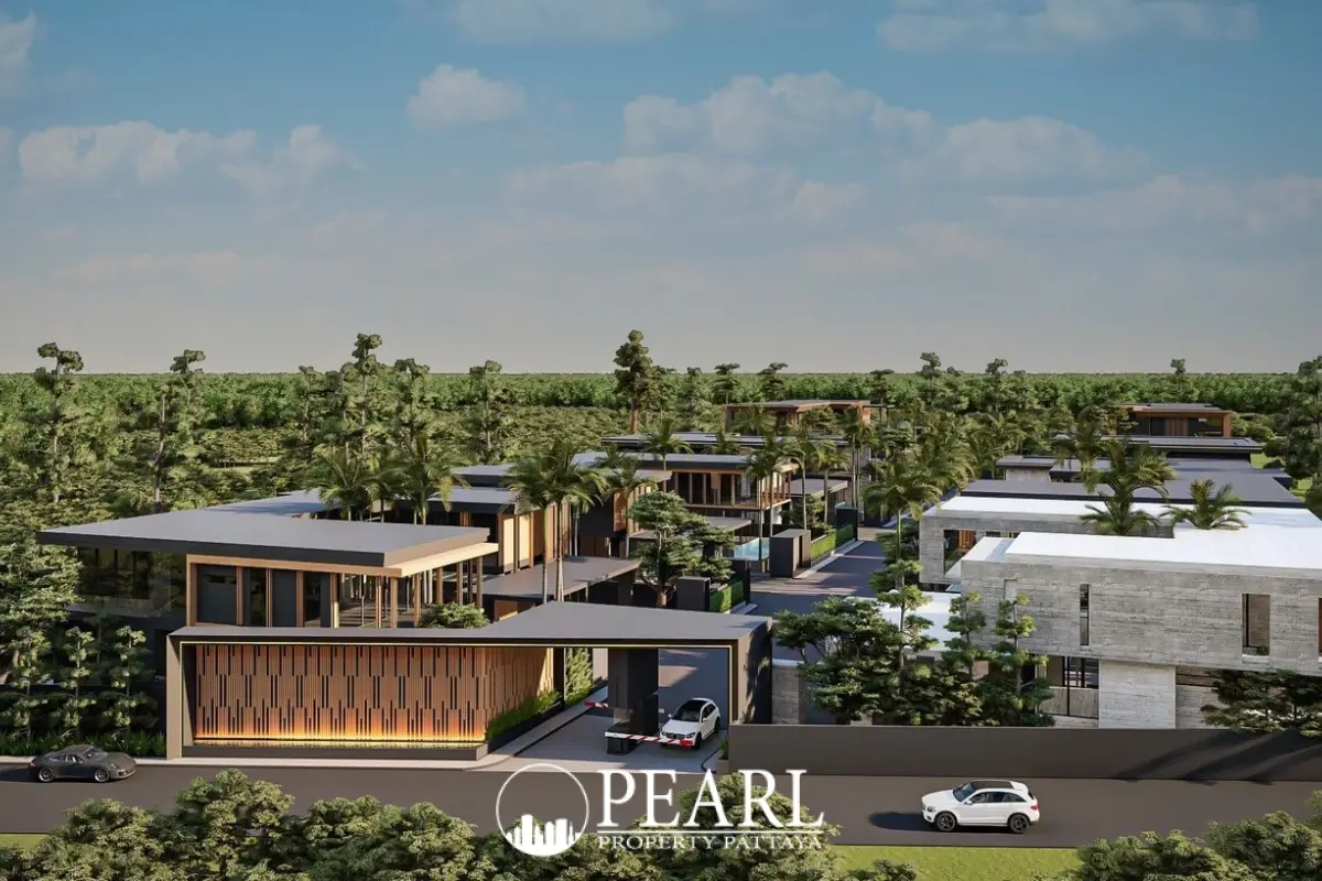 The Scenevanar aerial view of the modern condo complex entrance and multiple buildings nestled among green trees.