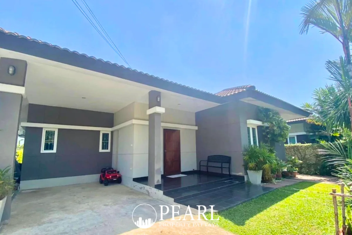 Baan Panalee security gate with a white booth, red and white barrier, and clear blue sky.