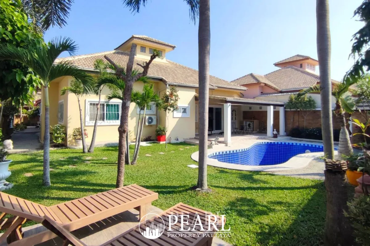 Classic Villa backyard with a blue tiled swimming pool, built-in steps, and a rocking chair on the patio.