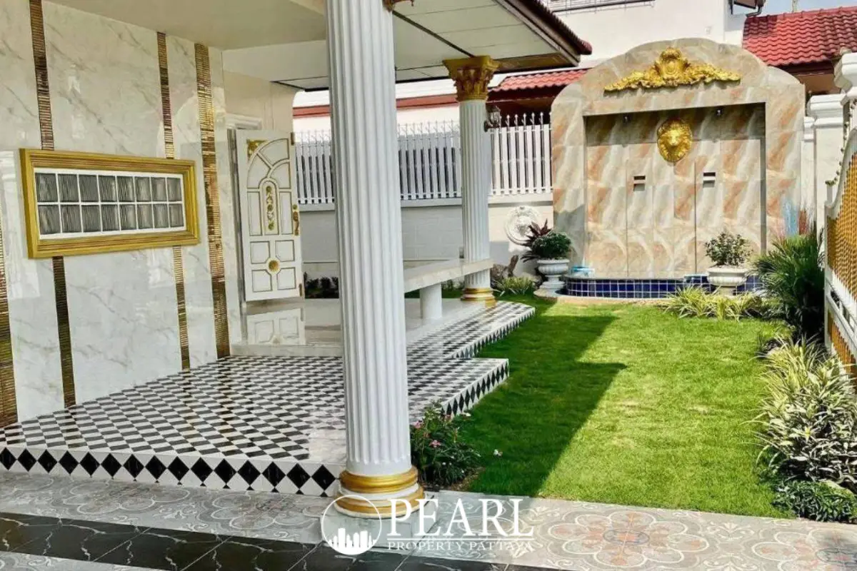 Eakmongkol 3 outdoor patio with black and white checkered tiles, white columns, and green lawn.