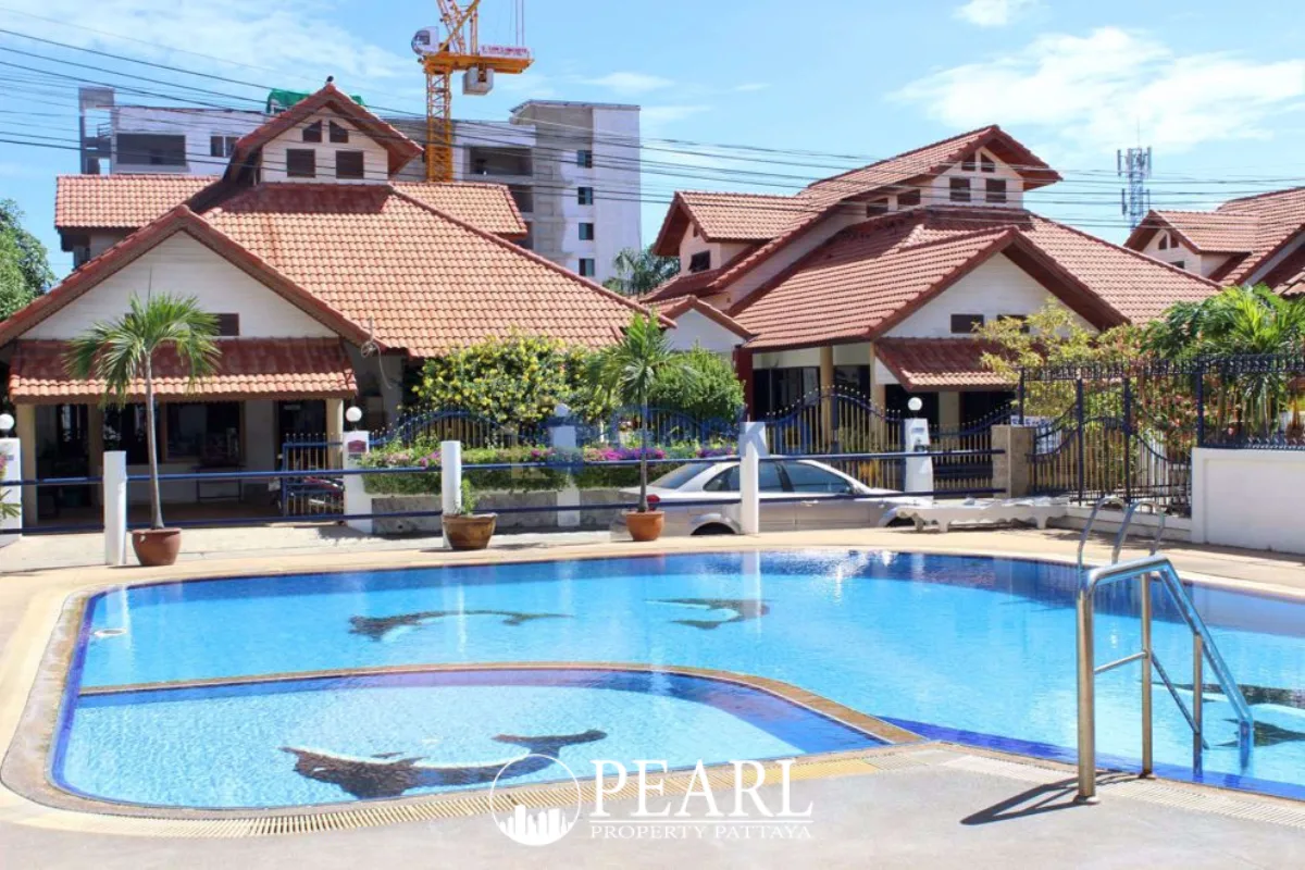 Eakmongkol Thepprasit modern two-story villa with a large swimming pool and covered patio seating area.