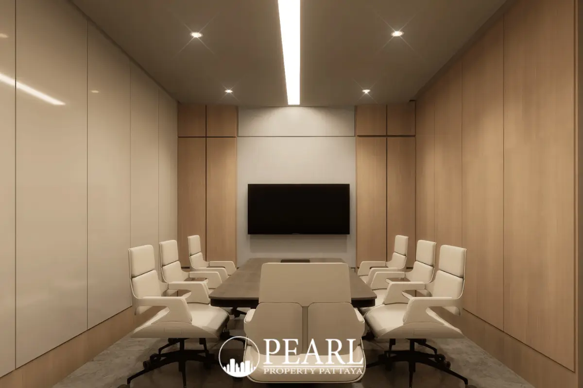 Baan Mae 12 – Onyx Grand Village modern conference room with a large table, white chairs, and wall-mounted TV.