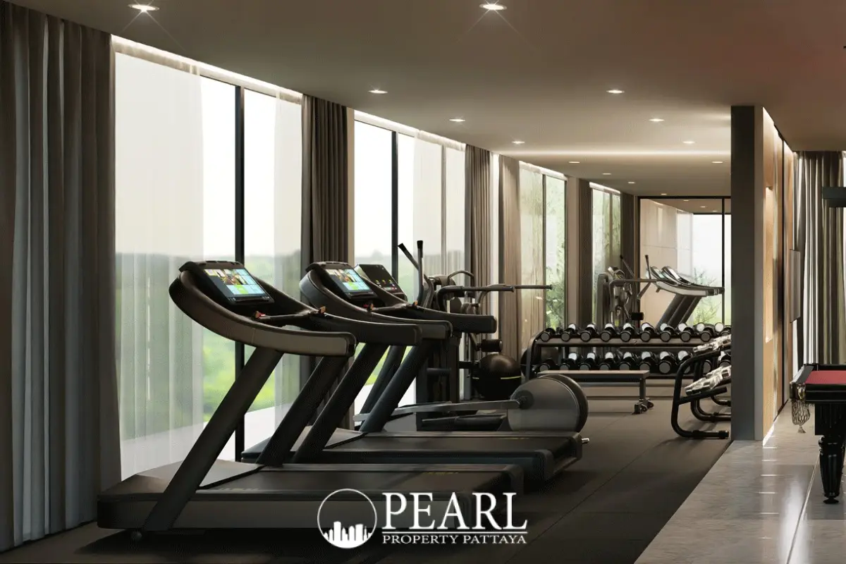 Baan Mae 12 – Onyx Grand Village fitness area with treadmills, weight rack, and large windows.