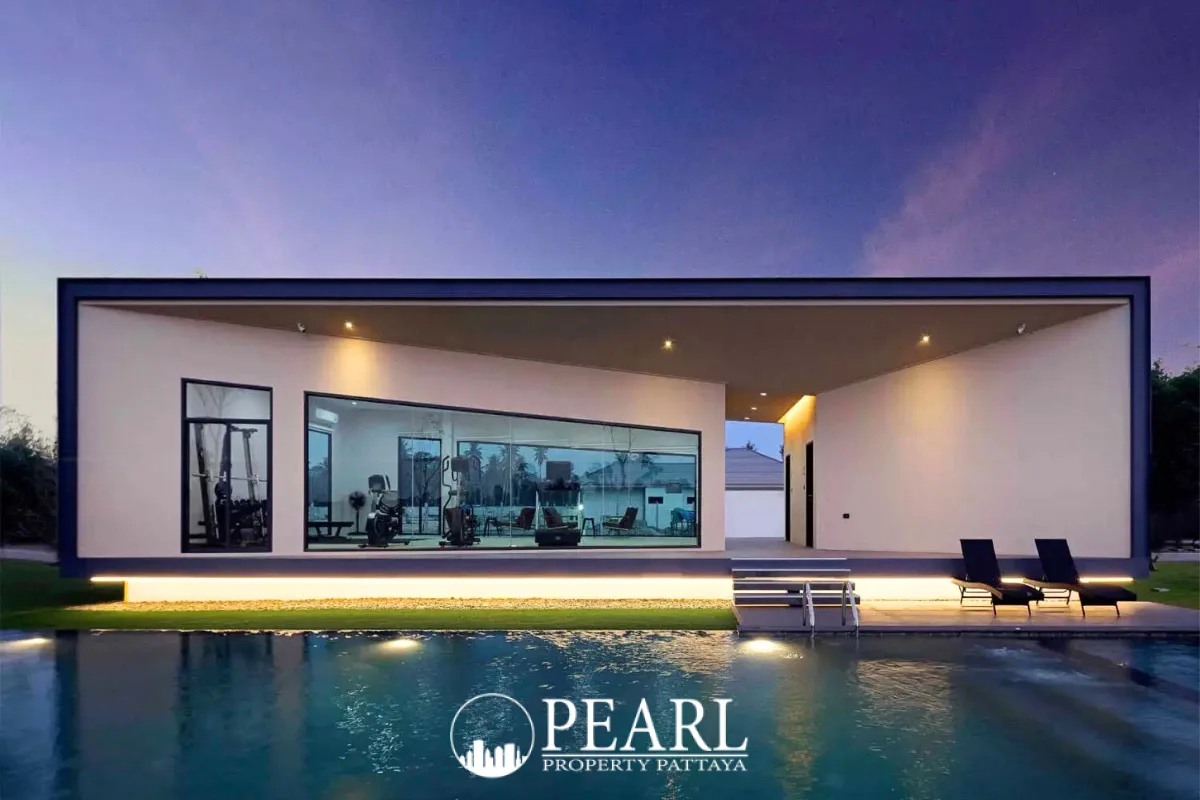 Baan Pattaya 6 modern entrance gate with security booth and lush landscaping under a bright sky.