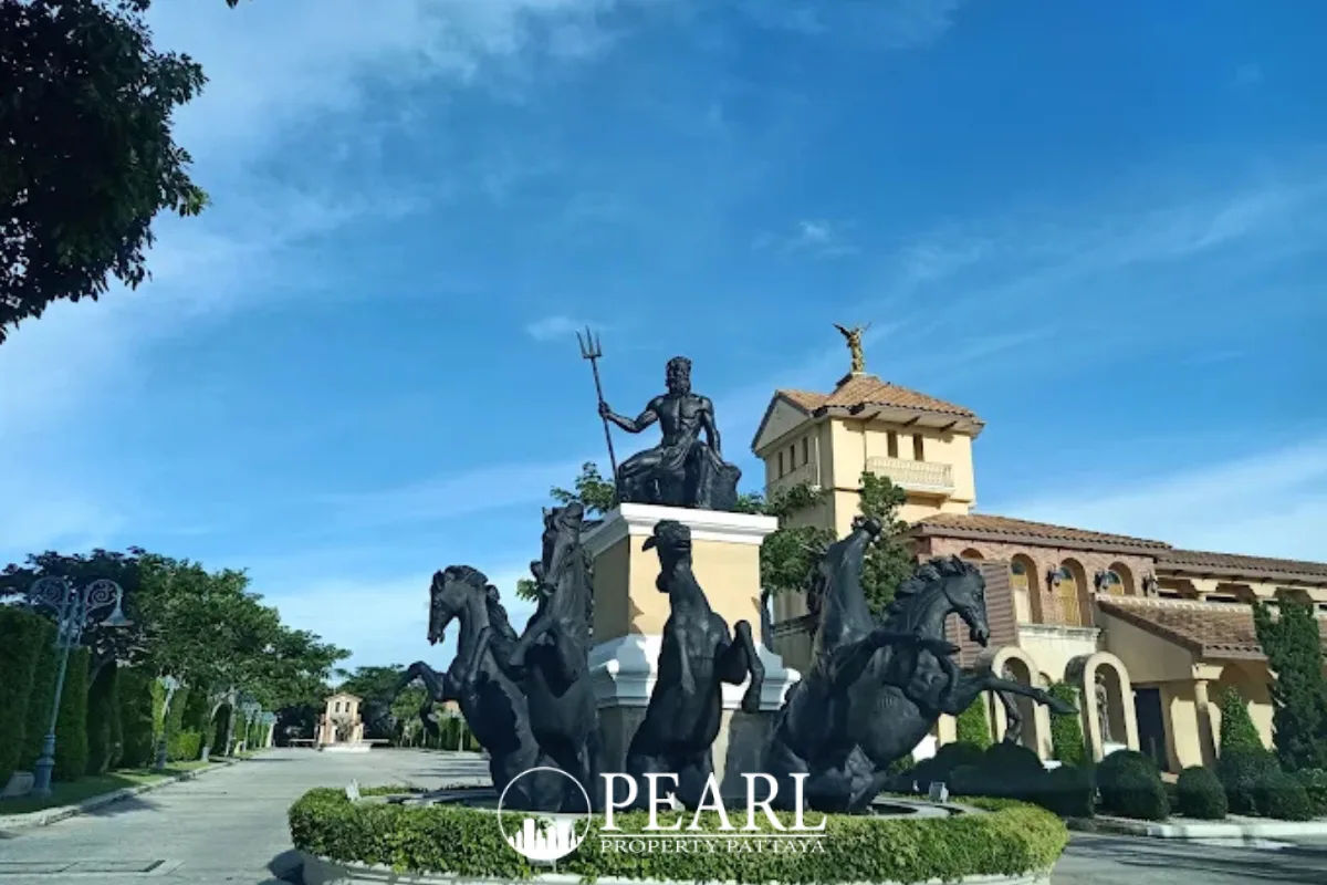 Nusa Chivani Pattaya grand entrance with a large Neptune statue fountain and horse sculptures, leading to a classical building.