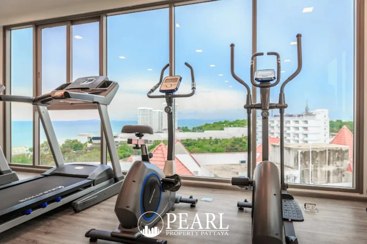 The Cloud fitness room with a treadmill, exercise bike, and elliptical machines overlooking the ocean.