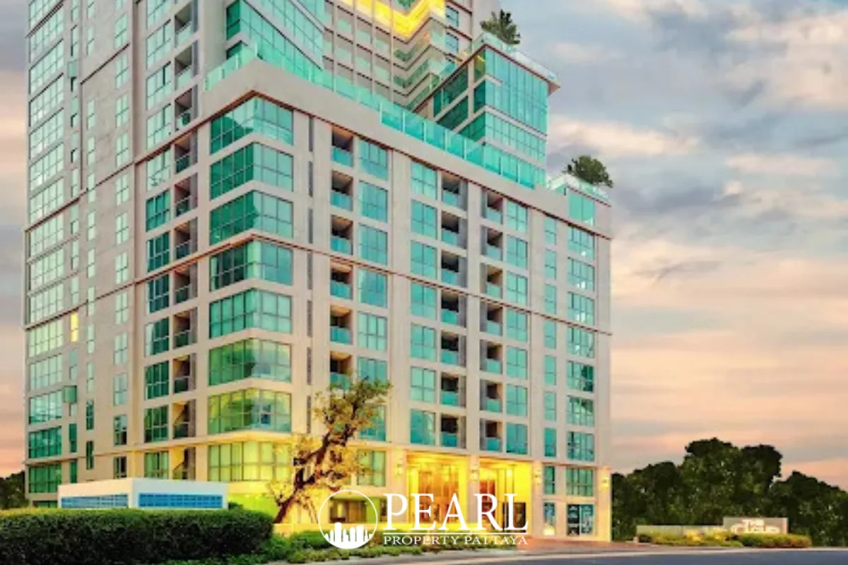 The Cloud exterior of a modern high-rise building with glass balconies at dusk in Pattaya, Thailand.