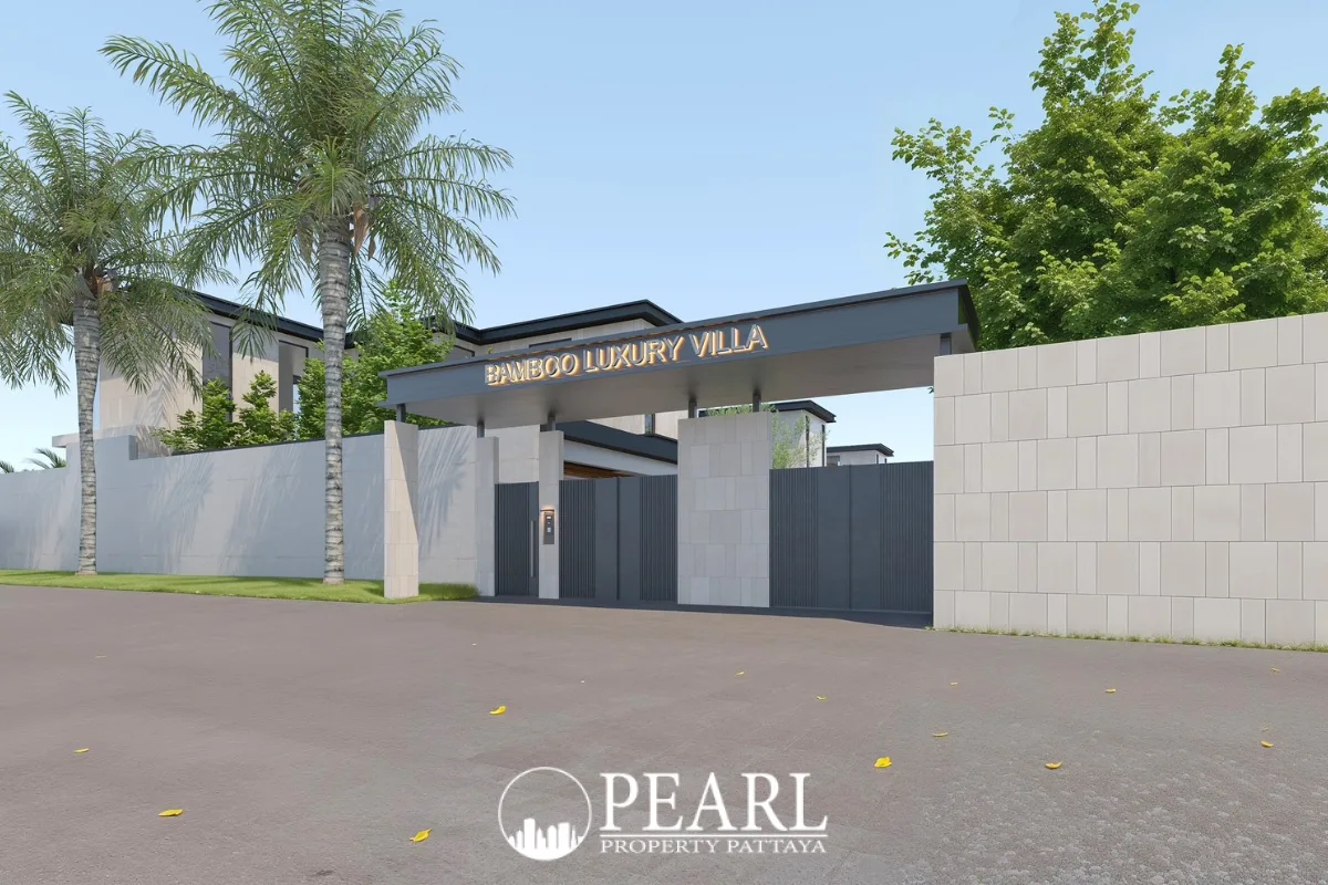 Bamboo Luxury Villa main entrance gate with prominent sign, modern gray walls, and tropical palm trees.