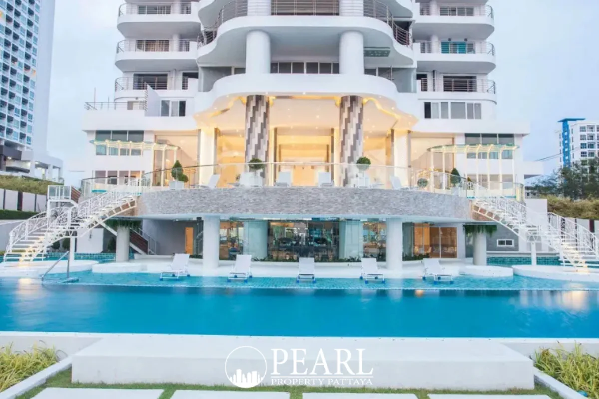 La Royale Beach panoramic view of beachfront property with multiple tall condo towers and lush greenery.
