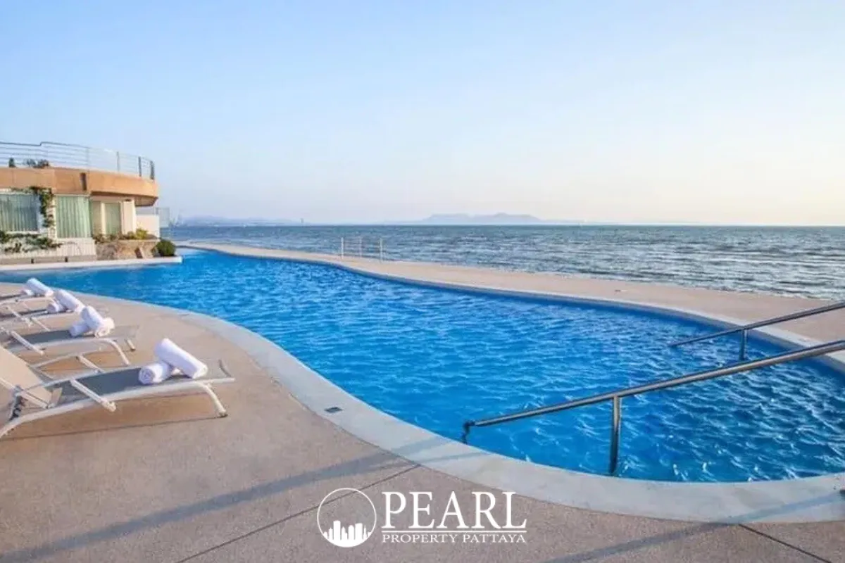 La Royale Beach grand entrance with dual staircases leading to a pool area and illuminated lobby at dusk.