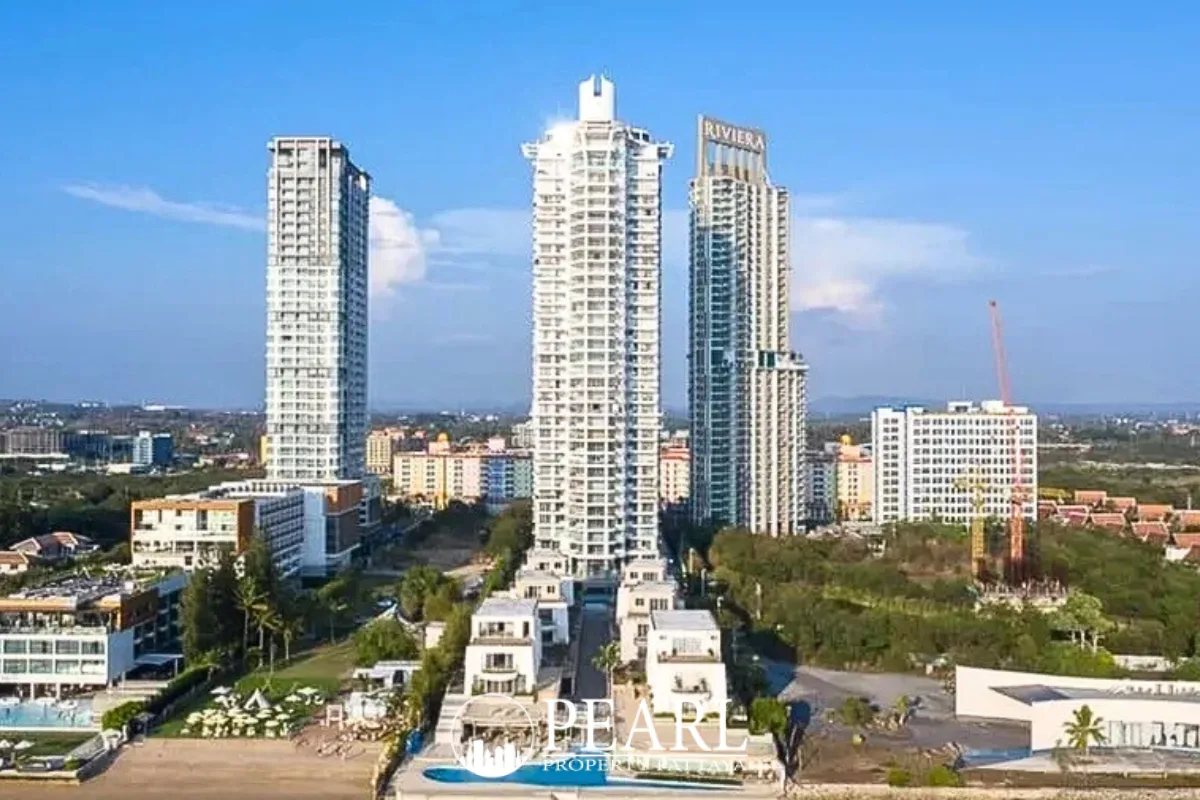 La Royale Beach aerial view of large outdoor swimming pool with lounge area and modern white buildings.