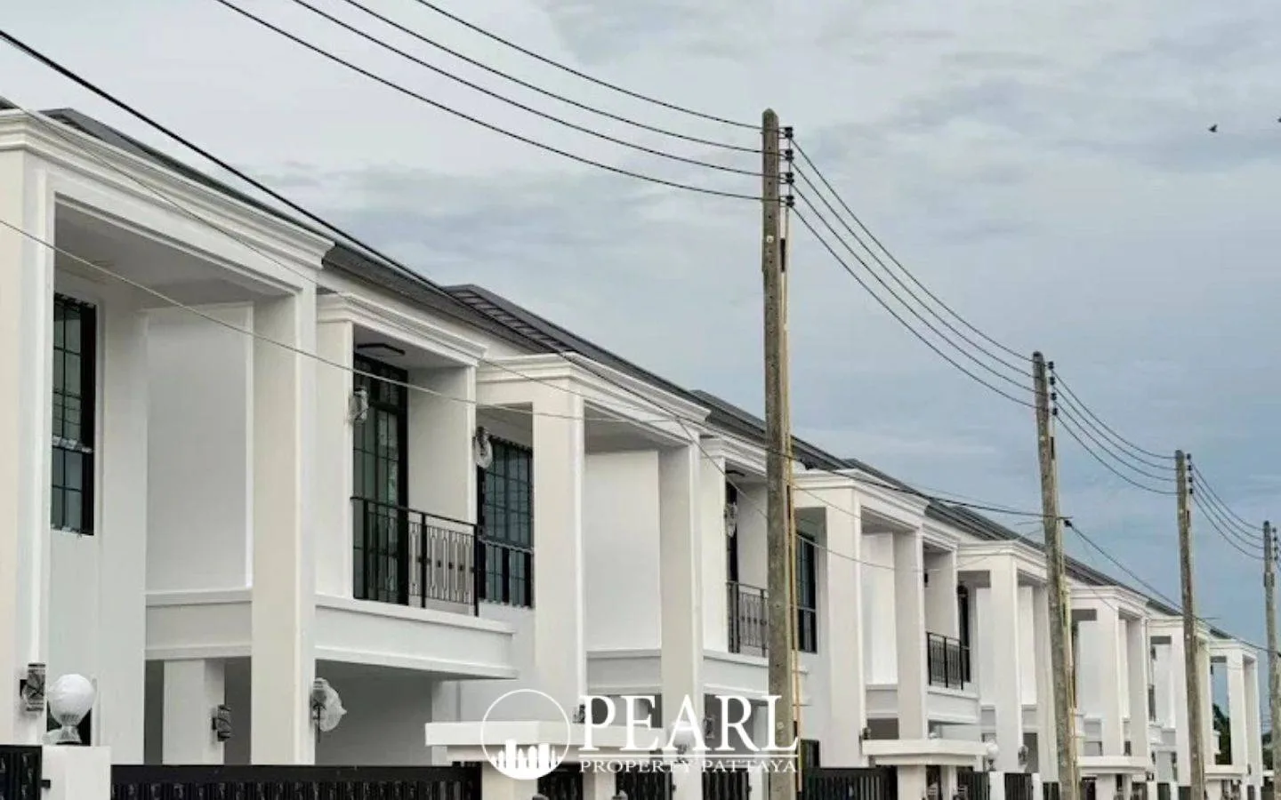 TW. Garden Hill main entrance gate with security booth, large sign, and construction area in Pattaya.