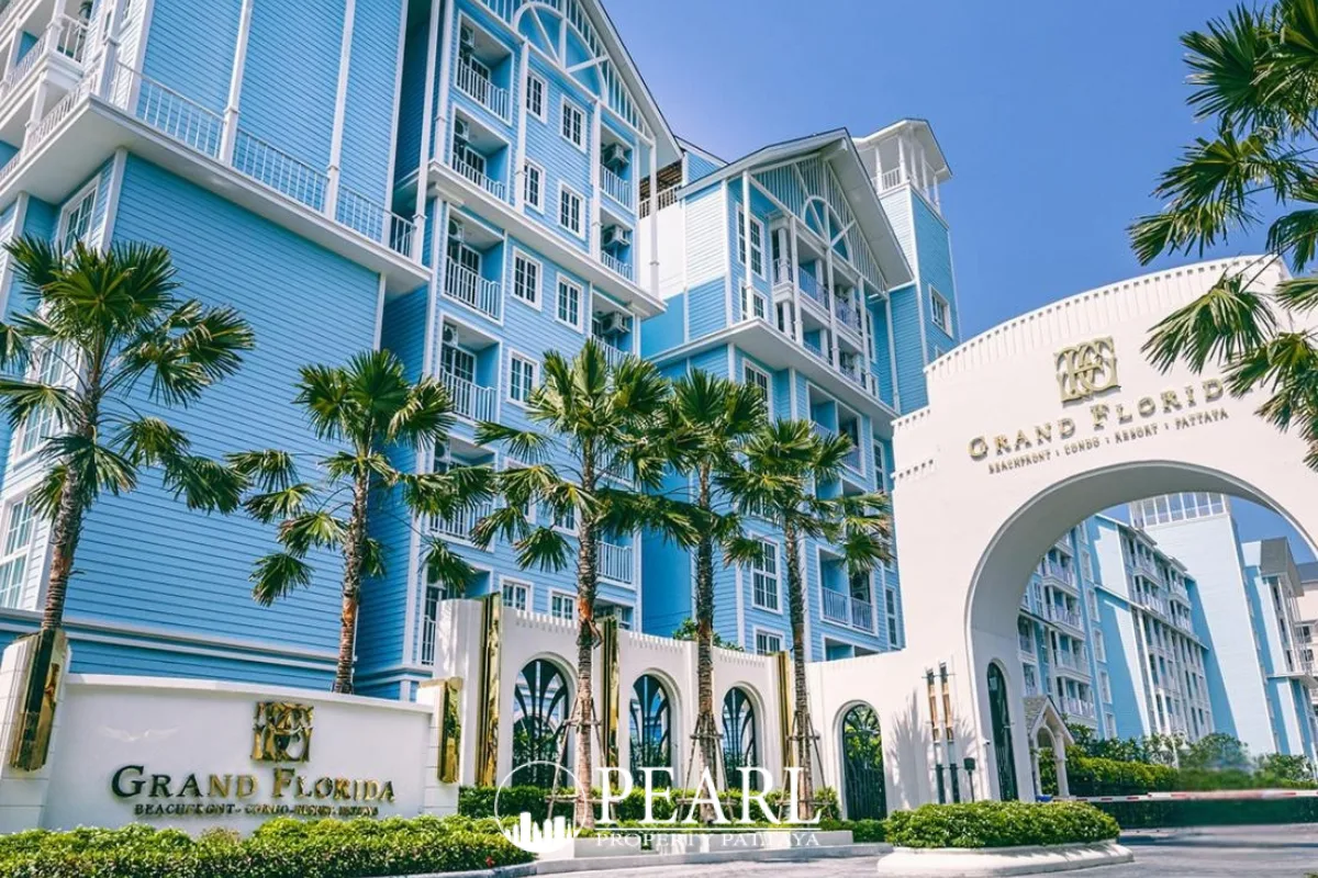 Grand Florida Beachfront Condo Resort Pattaya exterior, light blue buildings, palm trees, and main archway entrance sign.