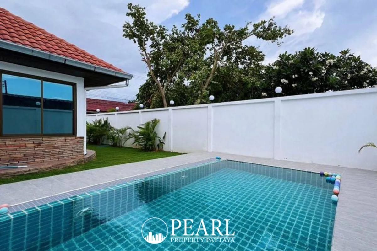 Royal View Village house exterior with a covered patio and green lawn.