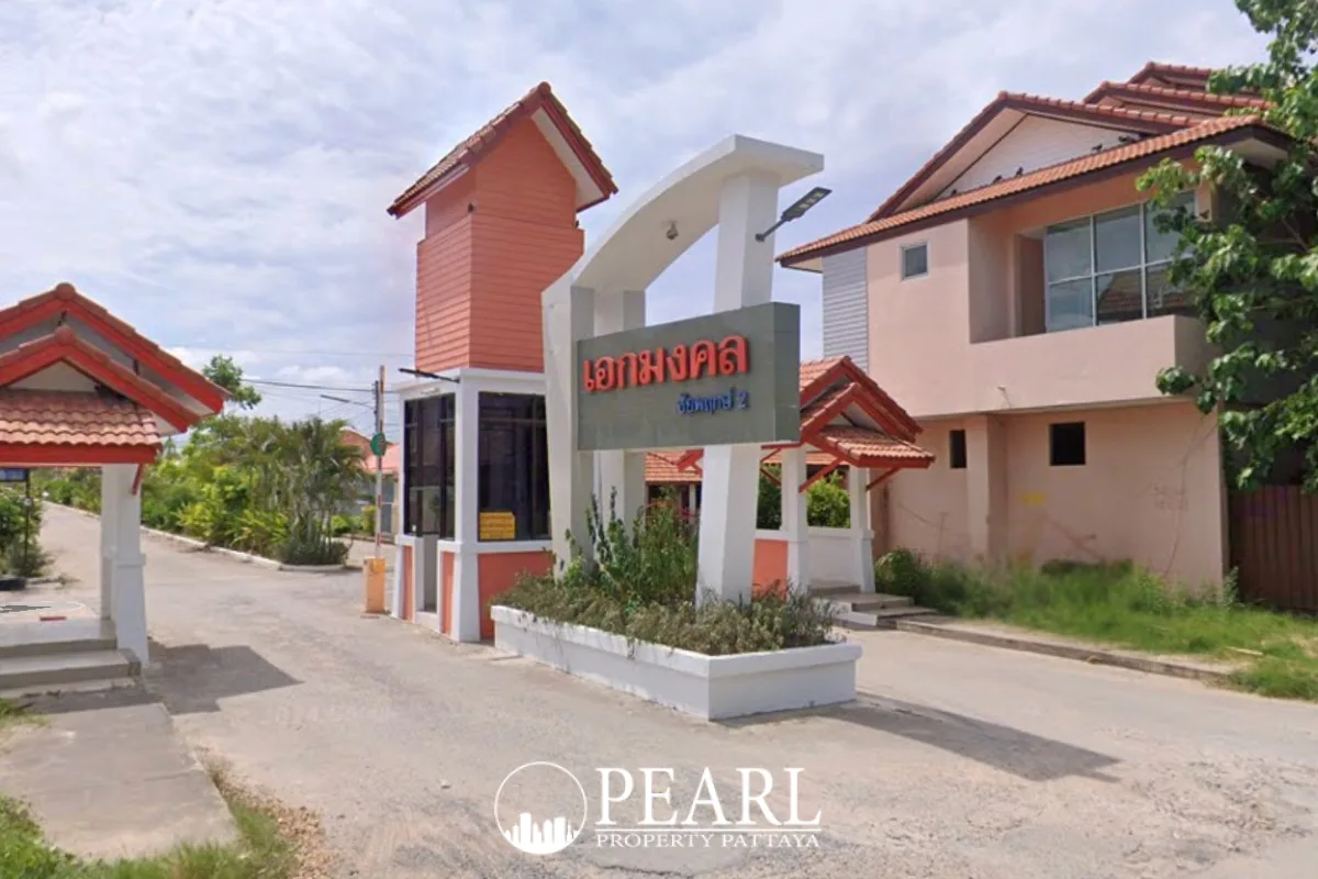 Eakmongkol Village Chaiyapruek 2 entrance gate with Thai signage, small guardhouses, and residential buildings.