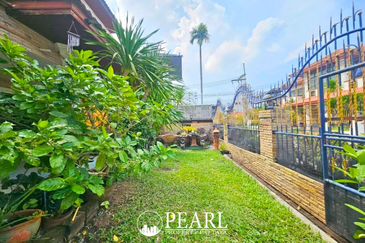 Eakmongkol Village Chaiyapruek 2 large cream house with covered carport, ornate gate, and tiled roof.