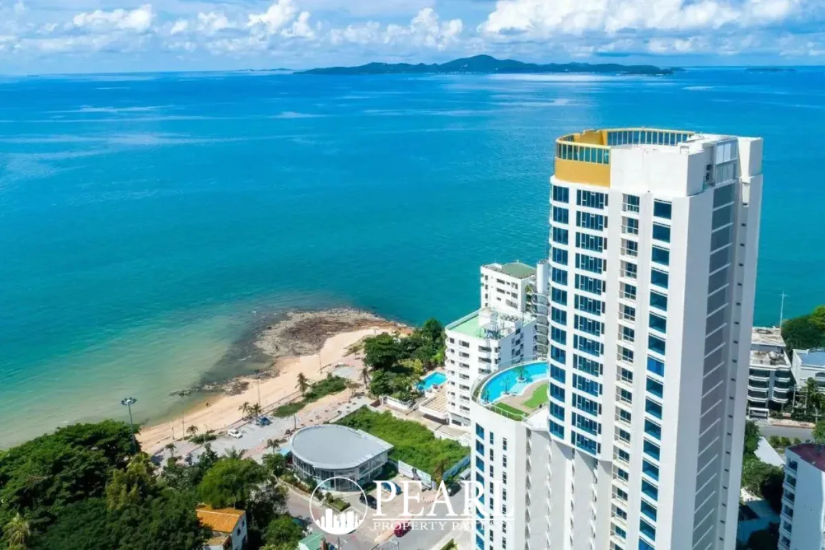 Sands Condominium aerial view of the tall white building overlooking the blue ocean and coastline in Pattaya.