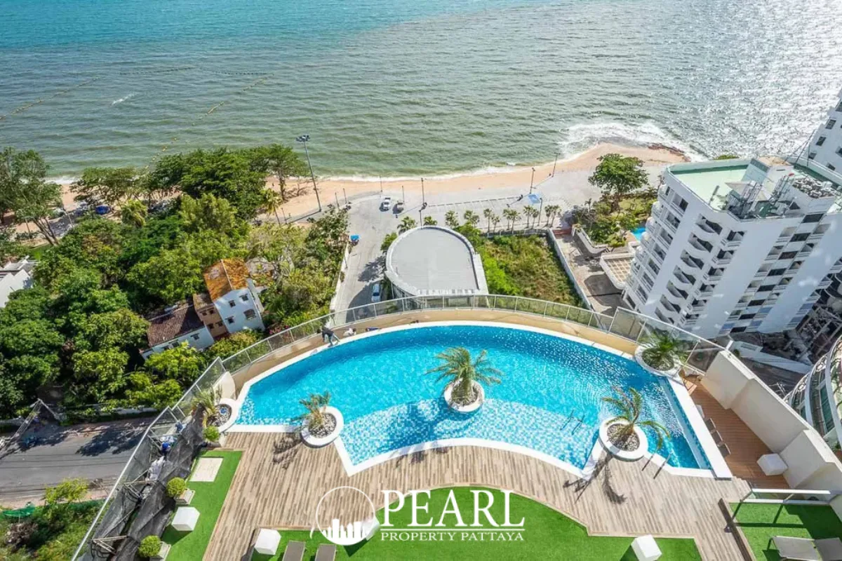 Sands Condominium rooftop infinity pool with palm trees, wooden deck, and stunning ocean views.