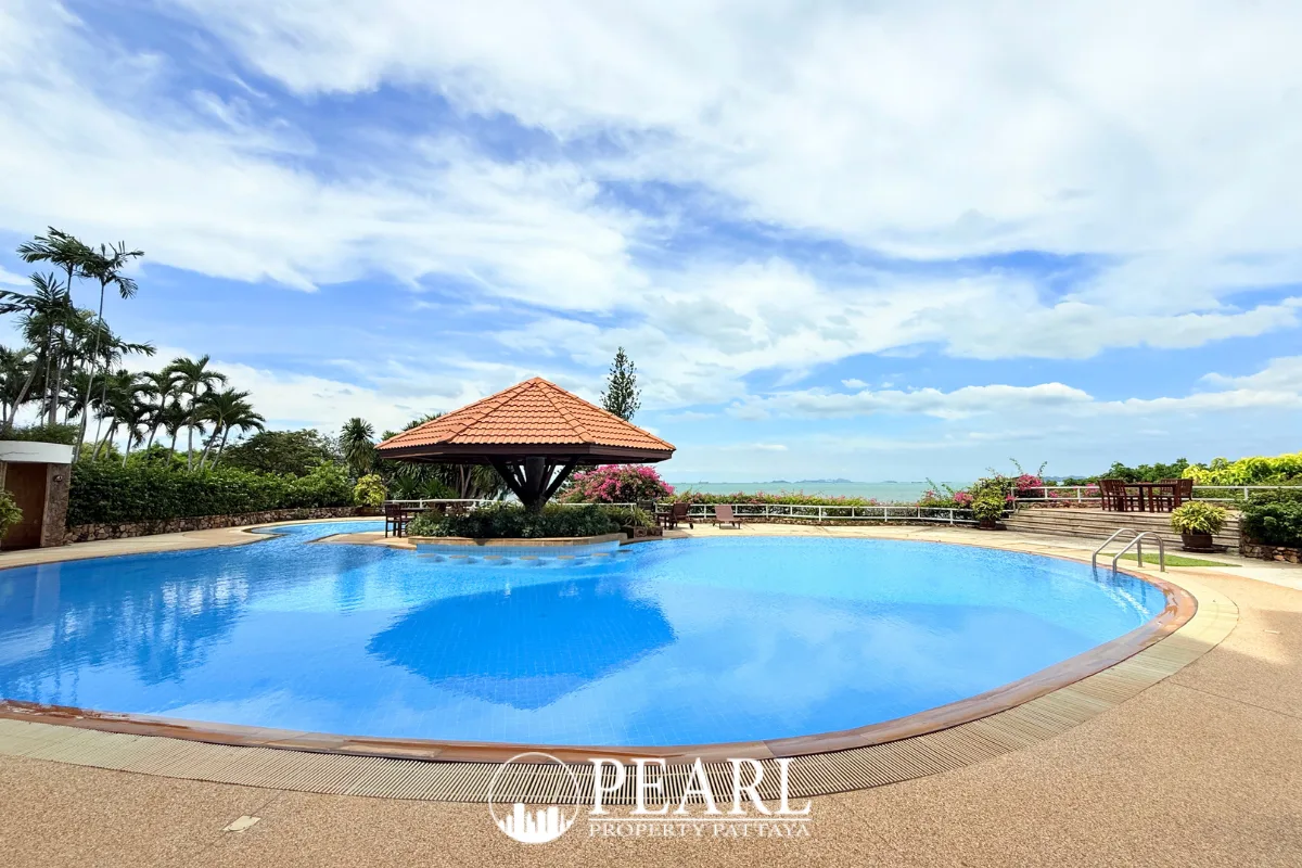 Garden Cliff Condominium 1 stunning panoramic ocean view from a cliffside with vibrant pink bougainvillea.