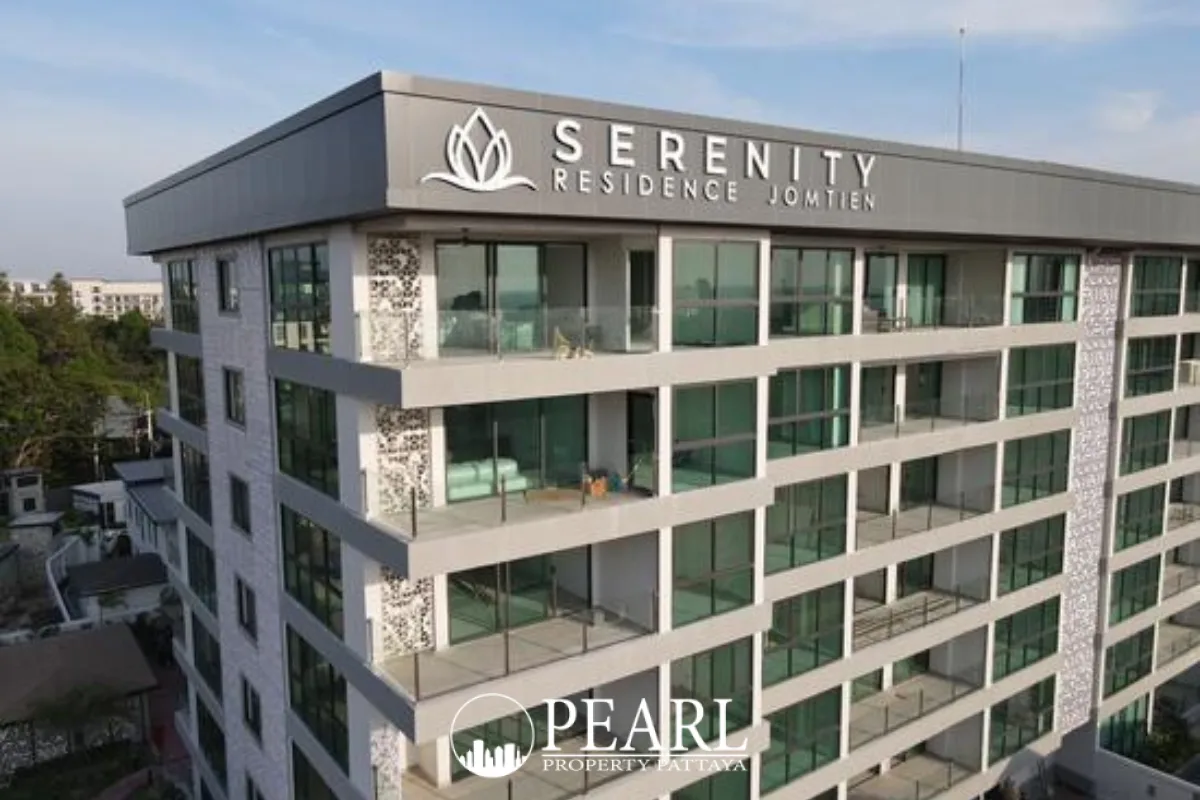 Serenity Residence Jomtien modern apartment building exterior with large windows and balconies under a clear sky.